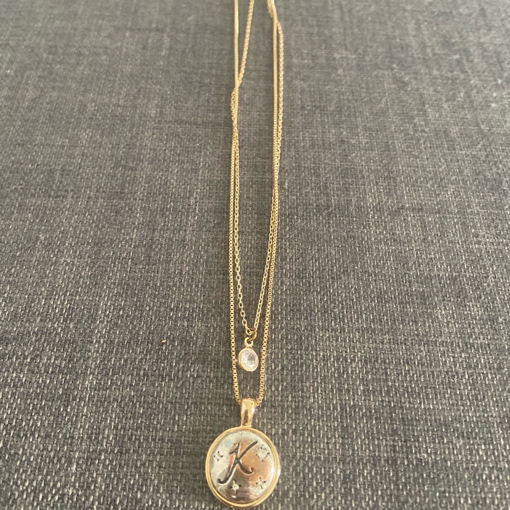 Gold necklace with a K on it